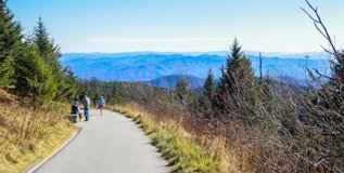 Clingmans Dome Paved Trail - Great Smoky Mountains Hikers walking along the steep paved trail toward the Clingmans Dome observation tower with scenic mountain ridges in the background